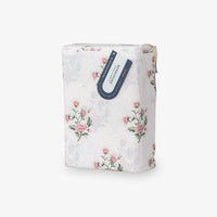 Floral-patterned product packaging with a visible brand label on a white background