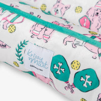Krissy Mast pickleball pups dog toy and pet bed set on a white surface.