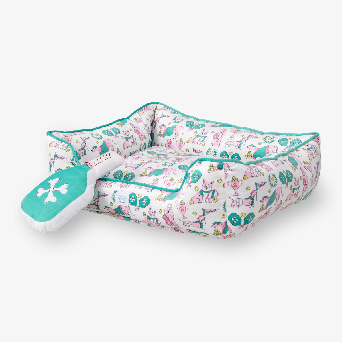 Pickleball pups dog toy and pet bed set on a white surface.