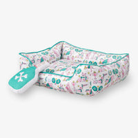 Pickleball pups dog toy and pet bed set on a white surface.