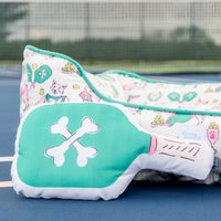 Teal pet bed with cartoon dog design on a blue surface