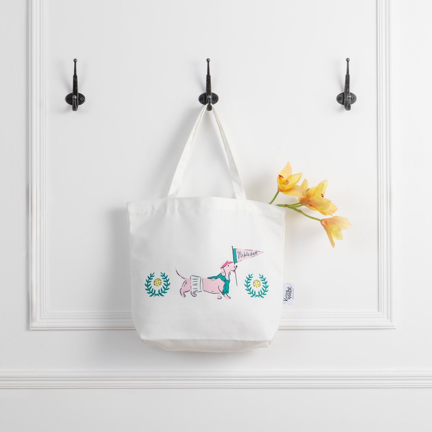 Pickleball pups tote hanging on a hook.