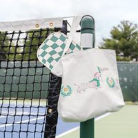 Tote bag with dog illustration hanging on a tennis net