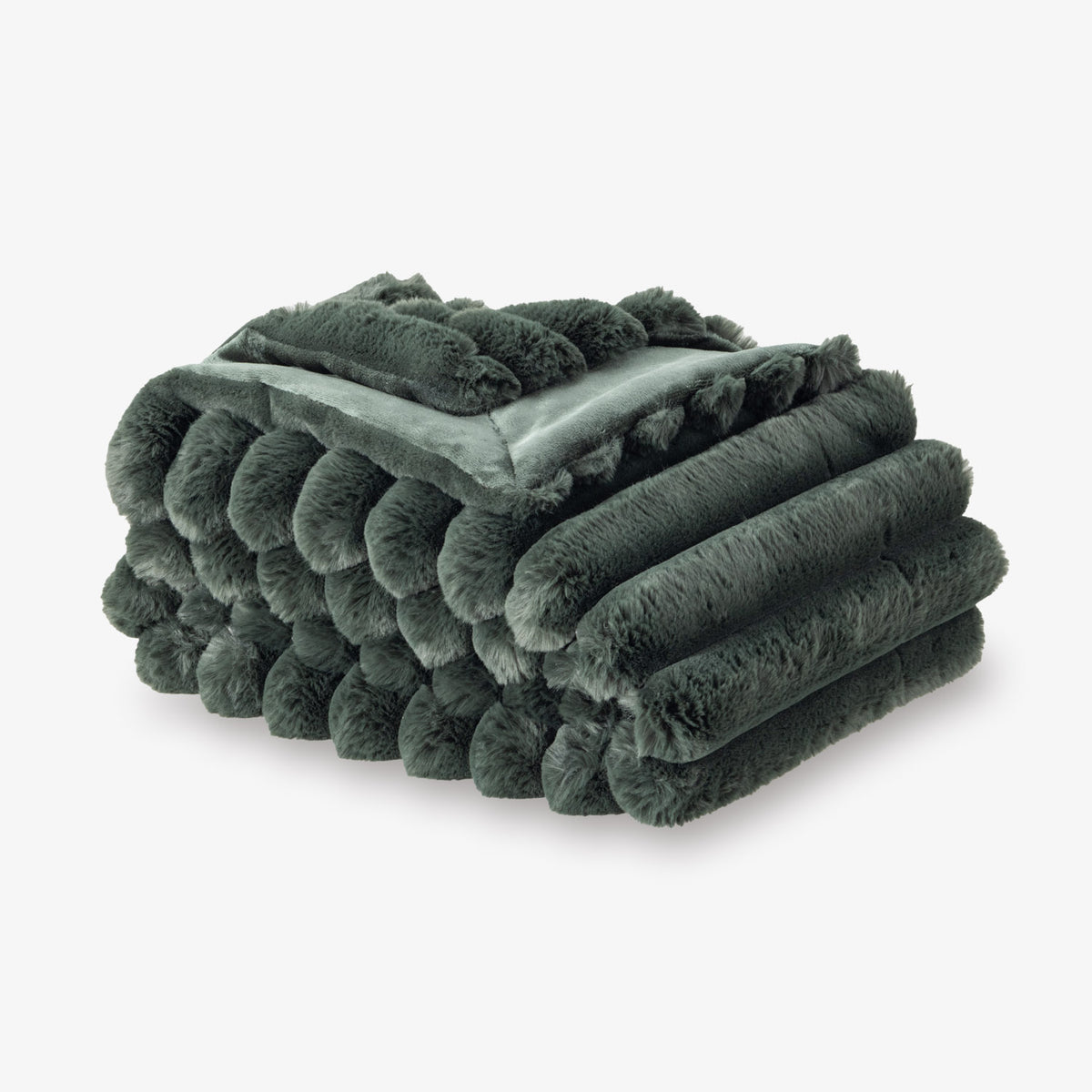 Folded dark green plush blanket on a white background