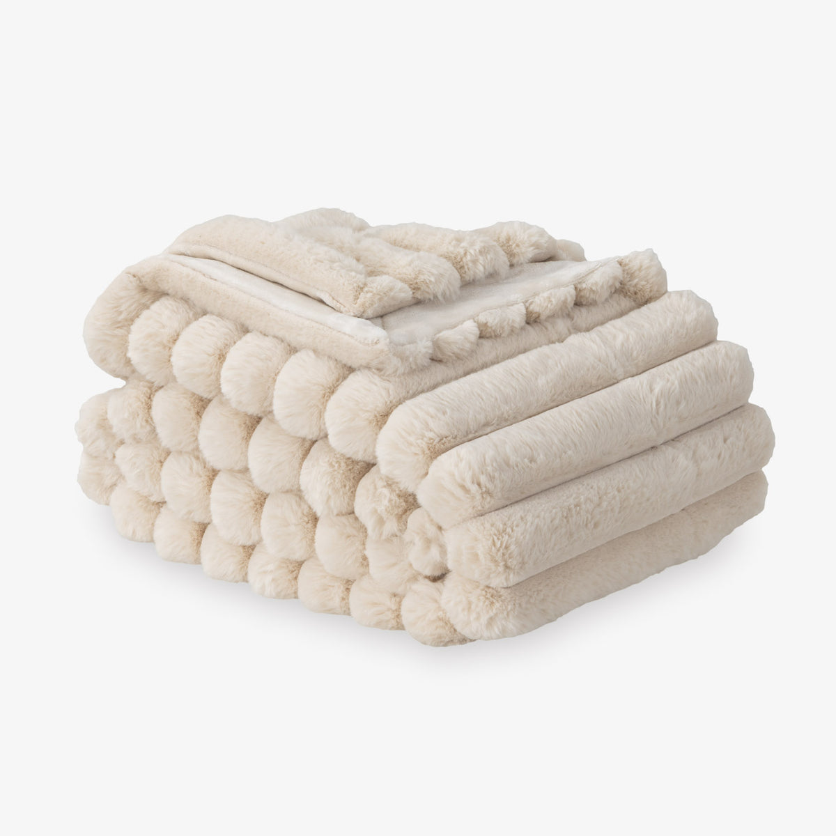 Beige blanket folded neatly on a white background