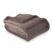 A greyPrimaLush Throw folded neatly on a white surface.