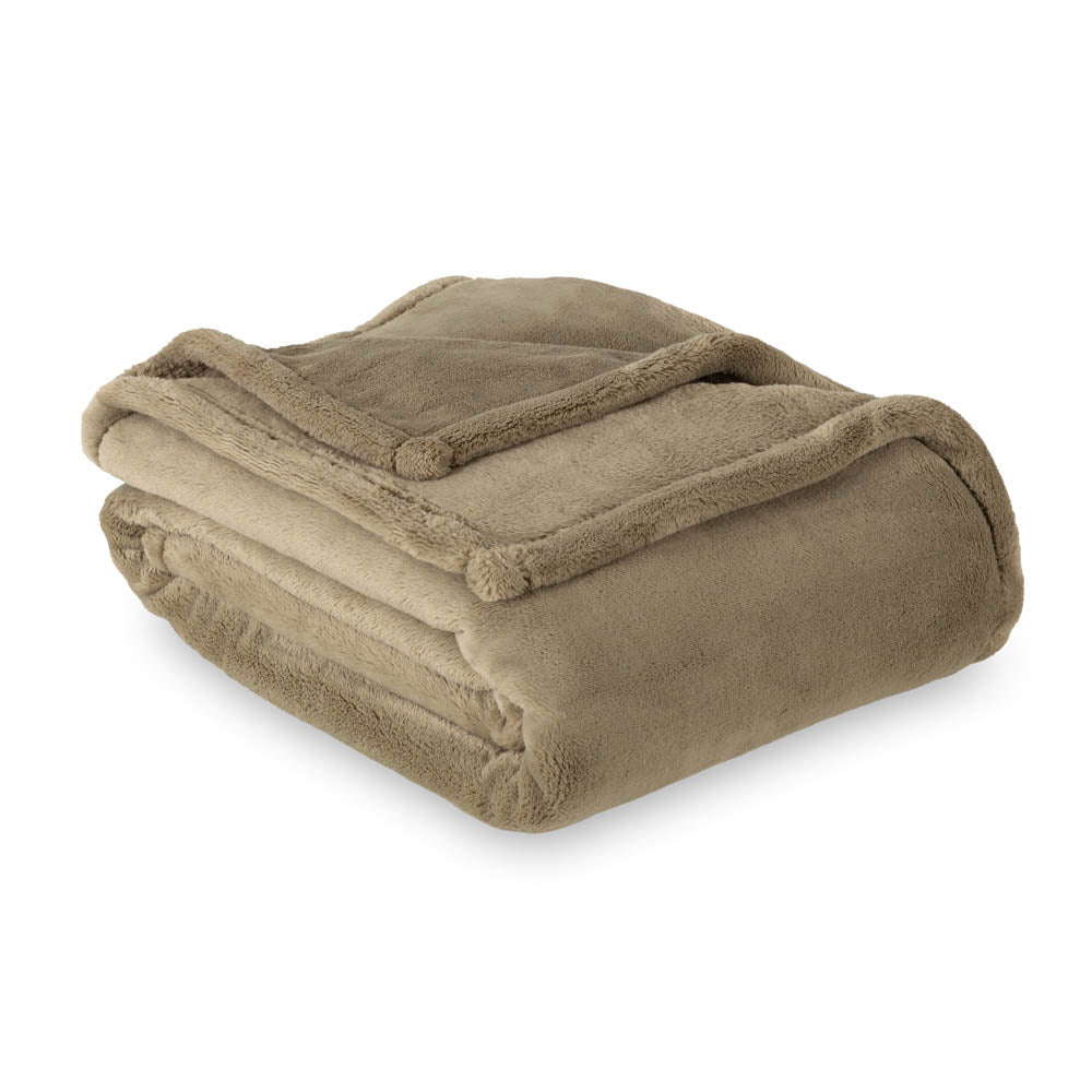 A green PrimaLush Throw folded neatly on a white surface.