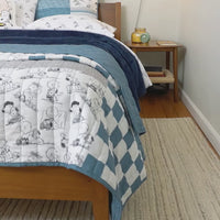 Video of a Peanuts Patchwork Quilt Set decorated on a bed.