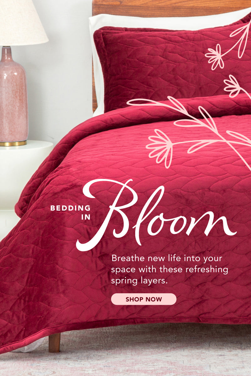 Bedding in Bloom. breathe new life into your space with these refreshing spring layers. Shop now. Image of a bed with a red quilt. 