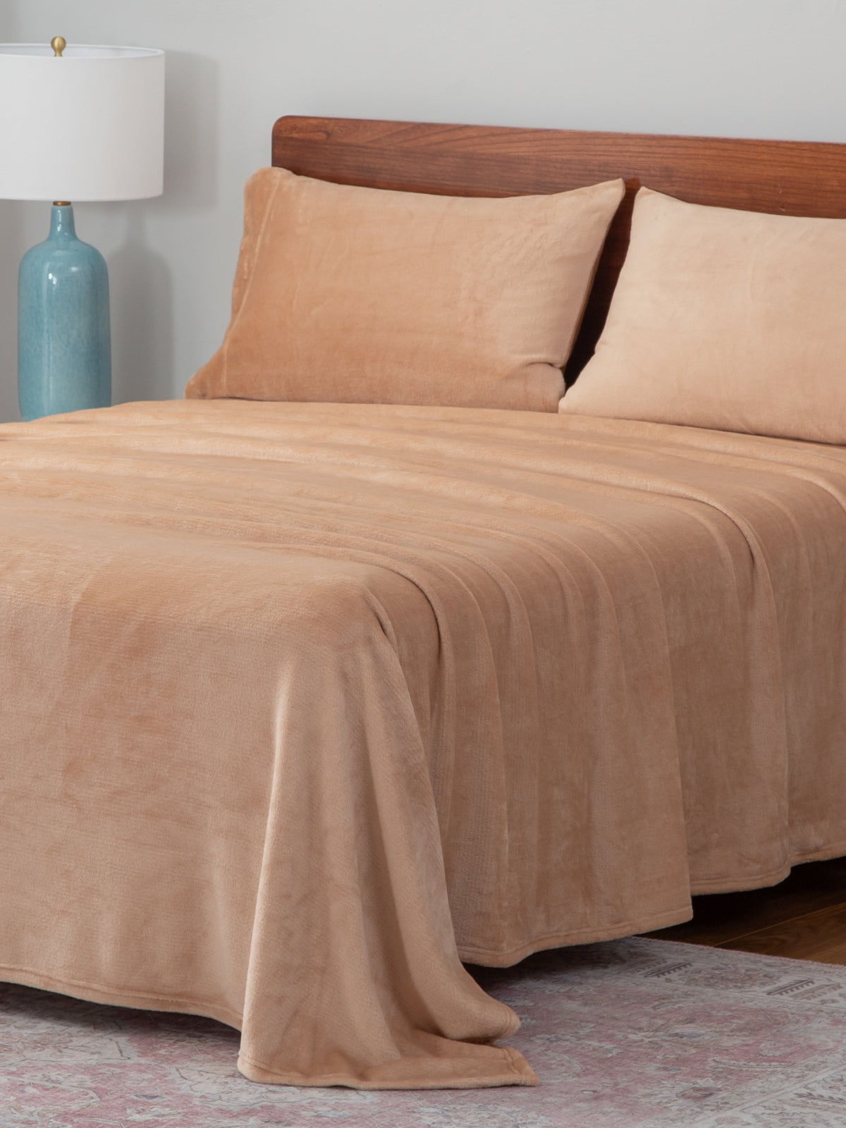 Sheets collection image featuring our VelvetLoft Sheets in Aruba Sand draped over a bed.