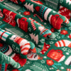 Close-up of Christmas-themed fabric with red, green, and white patterns.