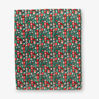 Christmas-themed patterned paper with red and green design on a white background
