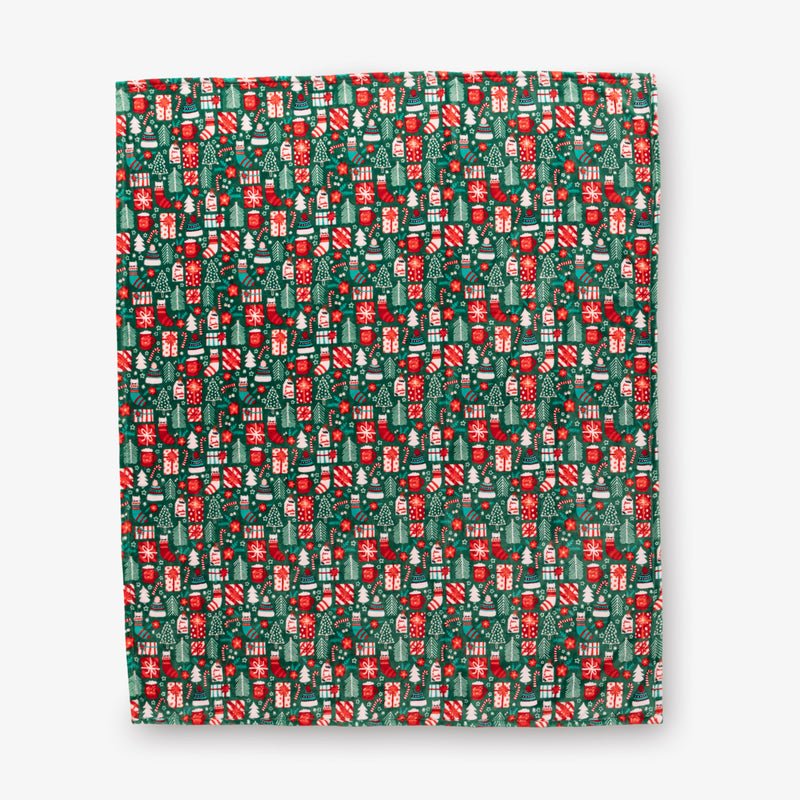 Christmas-themed patterned paper with red and green design on a white background