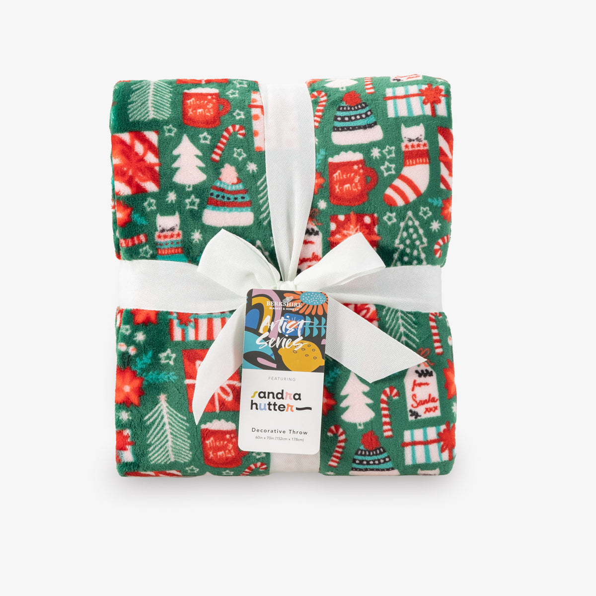 A folded holiday throw Christmas-themed pattern on a white background