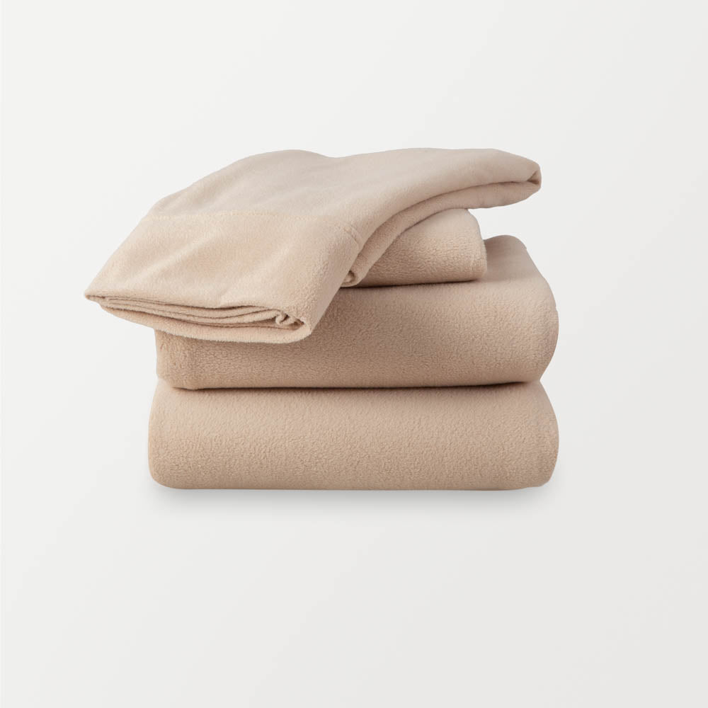 A stack of beige sheets neatly folded on a white background.