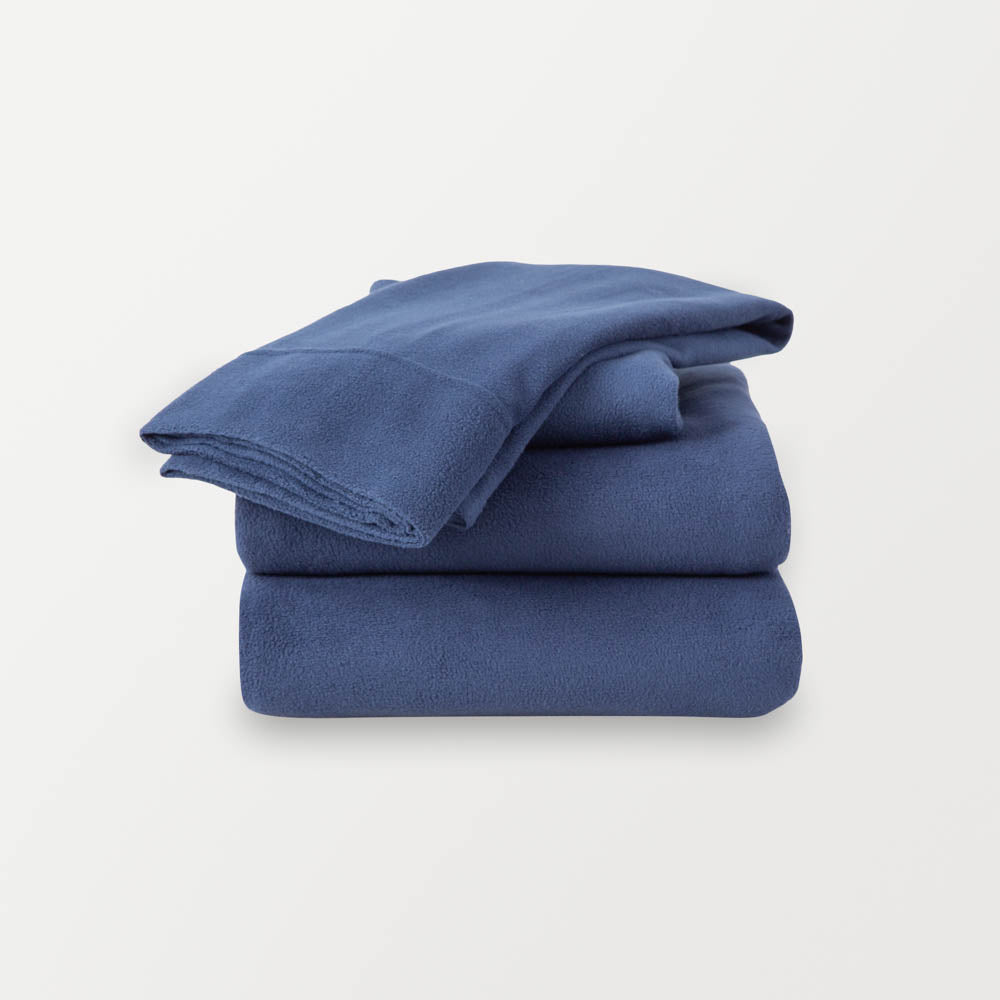 A stack of navy sheets neatly folded on a white background.