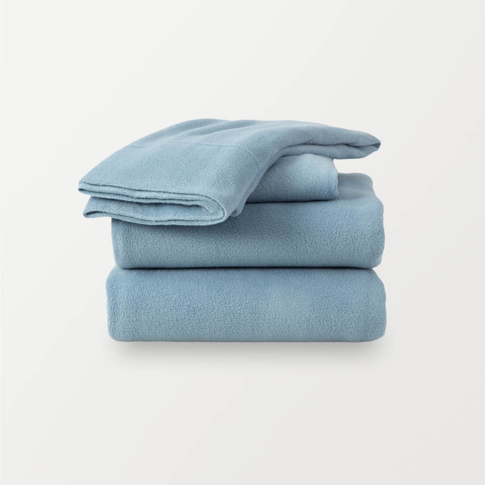 A stack of light blue sheets neatly folded on a white background.