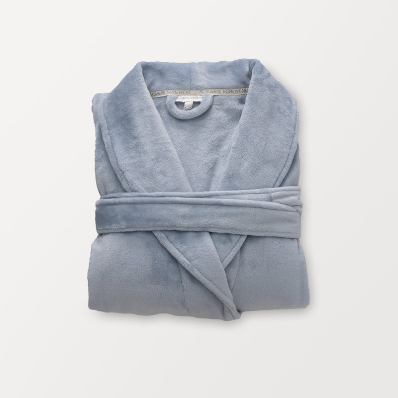 A blue VelvetLoft Luxury Plush Spa Robe folded neatly on a white surface.