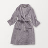 A purple VelvetLoft Luxury Plush Spa Robe laid flat on a white surface.