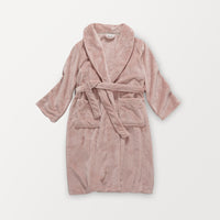 A pink VelvetLoft Luxury Plush Spa Robe laid flat on a white surface.