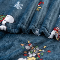 Blue fleece blanket with embroidered characters and festive designs.