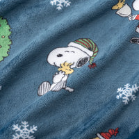 Blue fabric with embroidered design of a dog wearing a Santa hat and snowflakes.