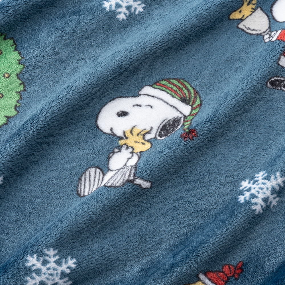 Blue fabric with embroidered design of a dog wearing a Santa hat and snowflakes.