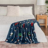 Decorative blanket with festive design draped over a bed in a bedroom setting.