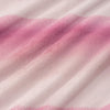 Close up of a pink ombre velvety plush bed blanket displaying its smooth plush texture.