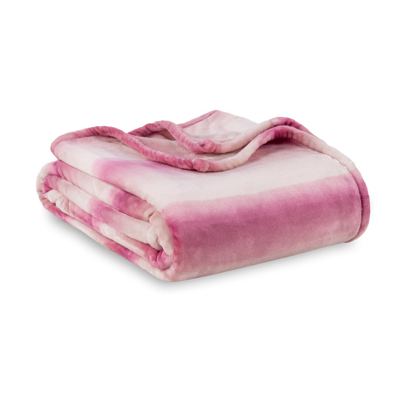 Pink ombre velvety plush bed blanket folded neatly on a white surface.