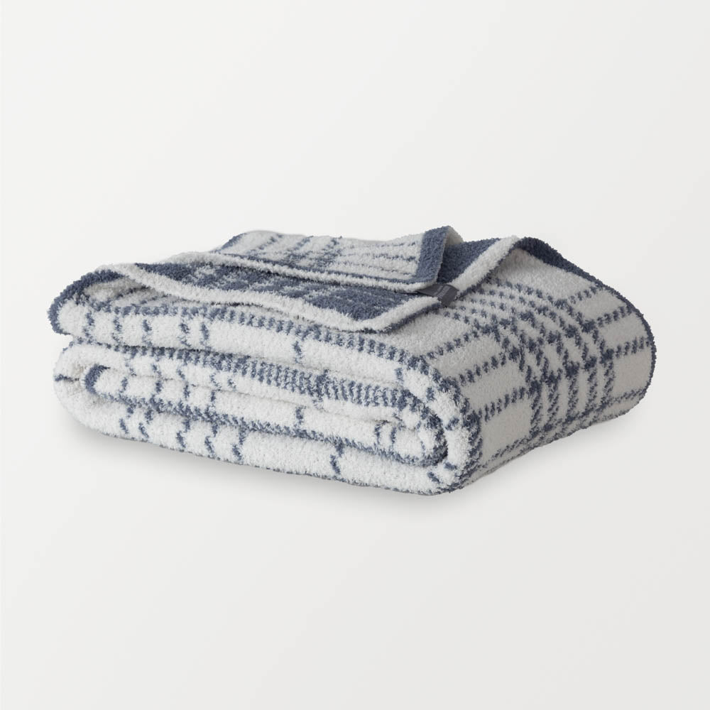 Image of a folded blue and white plaid throw