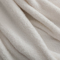 Close-up of the White Retro Comfort Plush Throw, highlighting its silky, textured fabric.