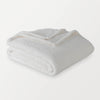 White Retro Comfort Plush Throw folded neatly against a white background. 