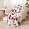 Decorative blanket with festive design draped over a chair in a living room.