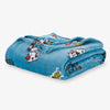 Folded blue blanket with cartoon character design on a white background