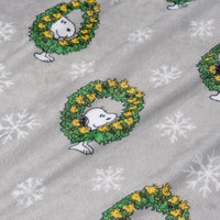 Fabric with Snoopy in wreaths and snowflakes on a gray background