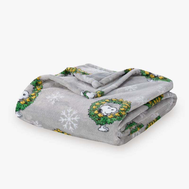 Gray blanket with cartoon character and snowflake design on a white background
