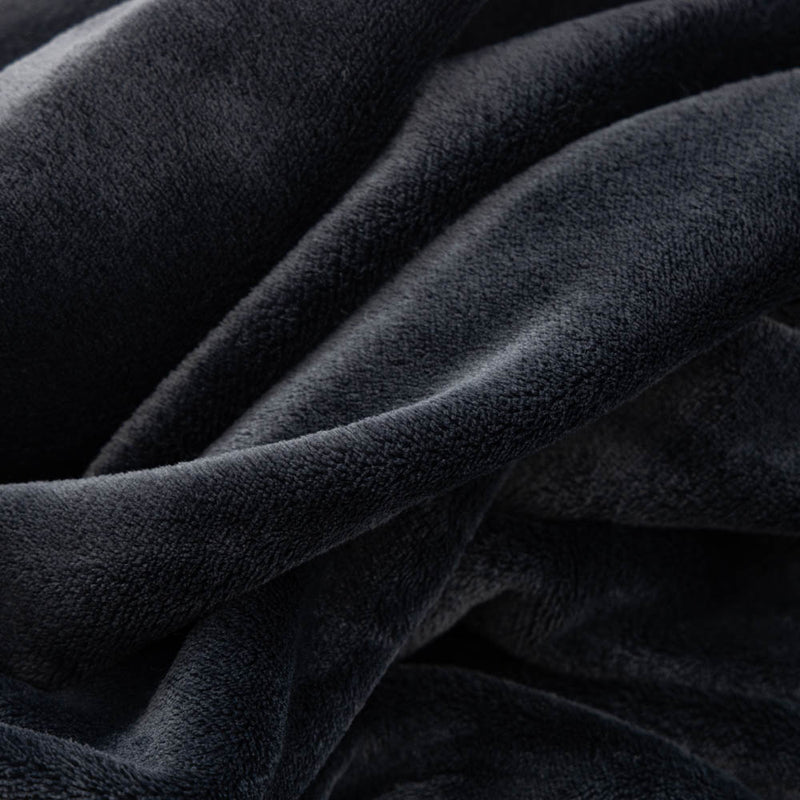 A close-up of the velvety, plush texture of a black PrimaLush Cape Wrap.