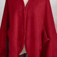 A close-up of the deep, velvety texture of a red PrimaLush Cape Wrap.