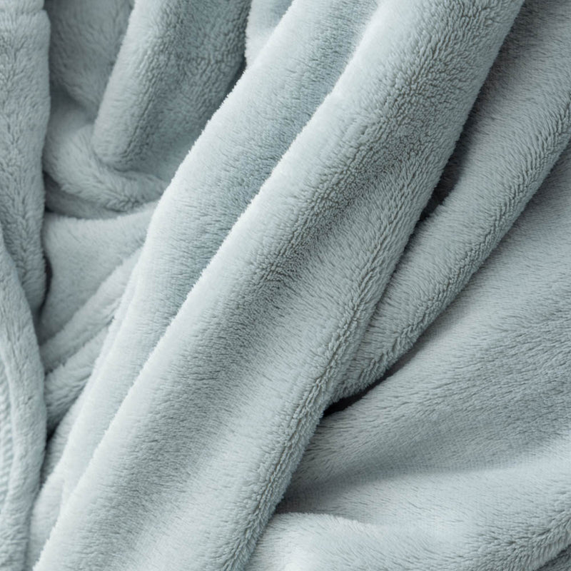 A close-up of the soft, fuzzy texture of a light blue PrimaLush Cape Wrap.