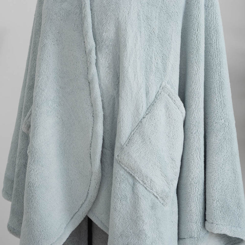 A close-up of the soft, fuzzy texture of a light blue PrimaLush Cape Wrap.