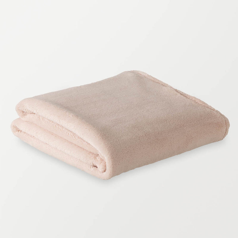 A folded blush pink PrimaLush Cape Wrap on a white background.