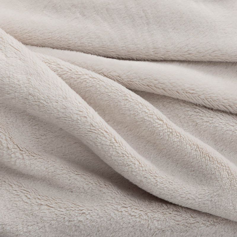 A close-up of the soft, fuzzy texture of a cream PrimaLush Cape Wrap.