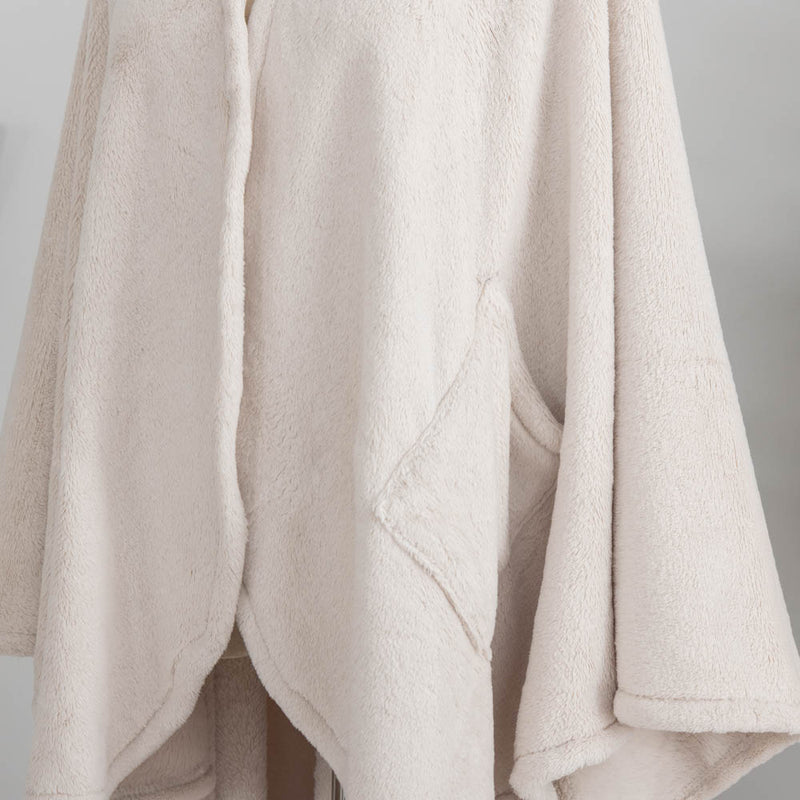 A close-up of the soft, fuzzy texture of a cream PrimaLush Cape Wrap.