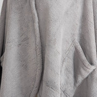 A close-up of the soft, plush texture of a gray PrimaLush Cape Wrap.