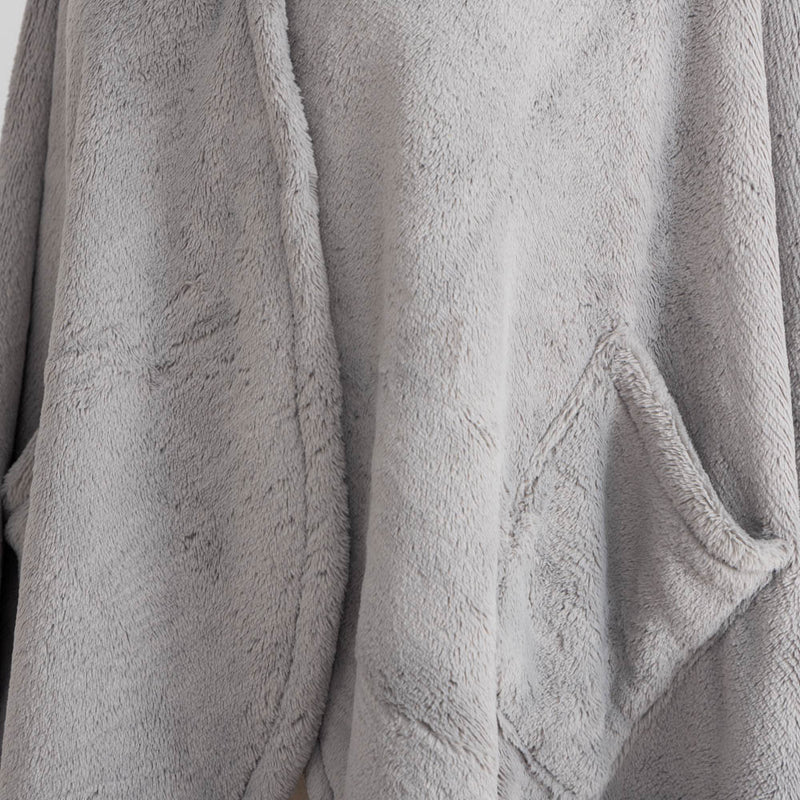 A close-up of the soft, plush texture of a gray PrimaLush Cape Wrap.