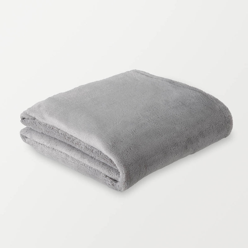 A folded gray PrimaLush Cape Wrap on a white surface.