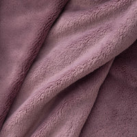 A close-up of the luxurious, velvety fabric of a purple PrimaLush Cape Wrap.