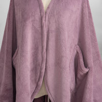 A close-up of the luxurious, velvety fabric of a purple PrimaLush Cape Wrap.