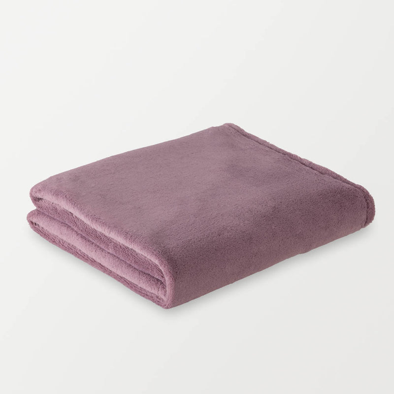 A folded purple PrimaLush Cape Wrap resting on a white background.